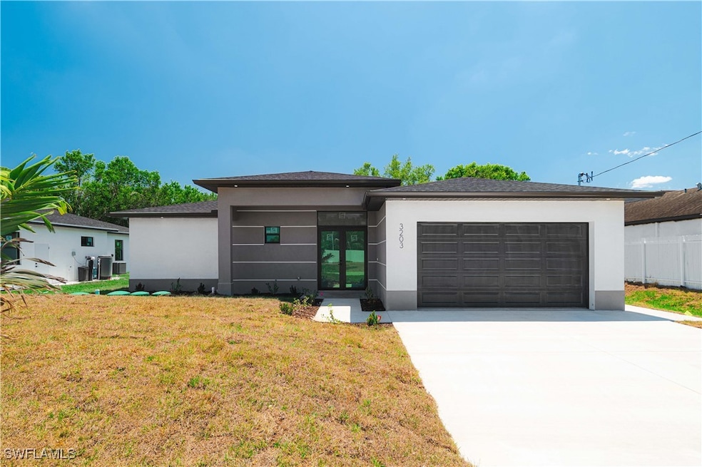 Prairie-style home featuring stucco siding, a gara