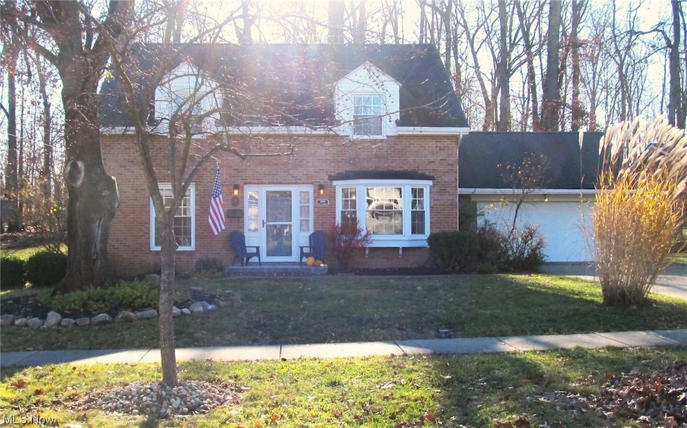 Brick cape cod with 2 car garage.
