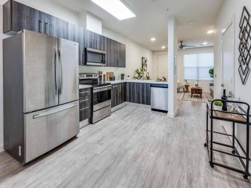 Kitchen featuring stainless steel appliances, lig