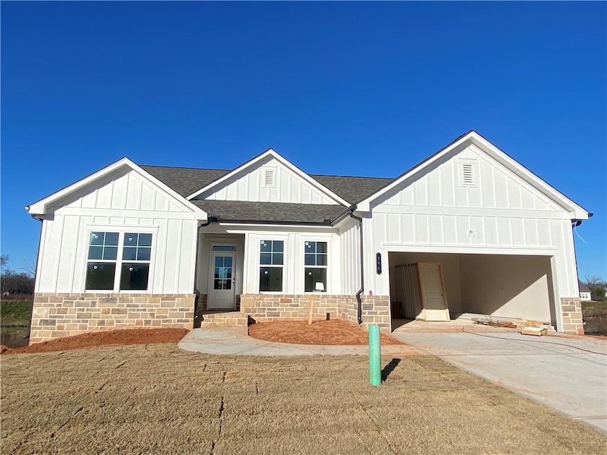 View of front of home with a garage and a front ya