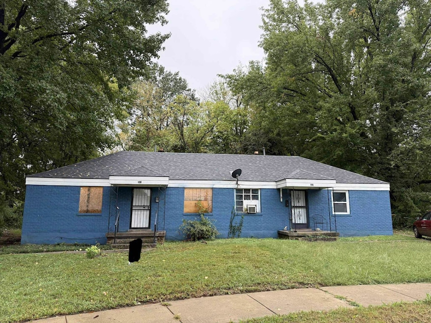 Single story home with a front yard, brick siding, and roof with shingles
