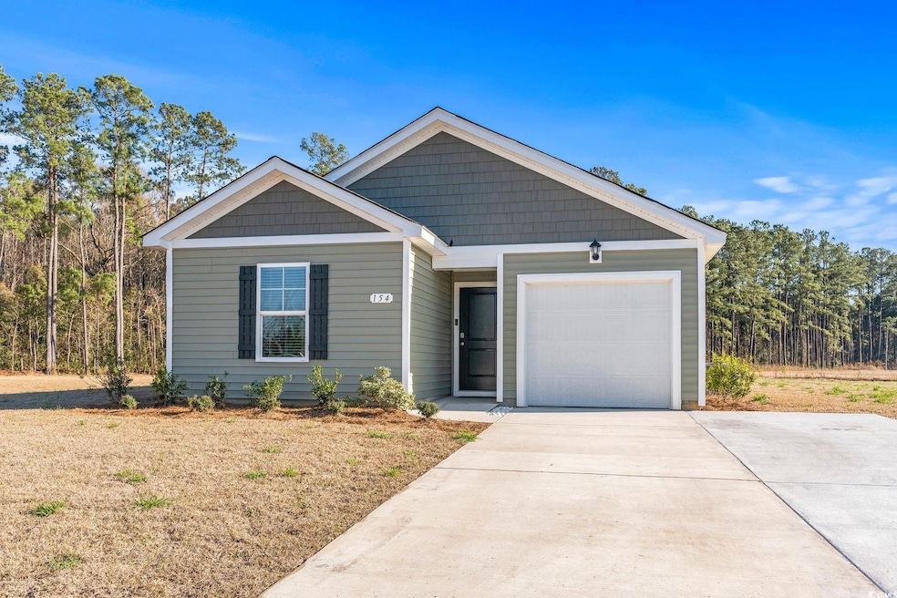 View of front of home with driveway and an attache