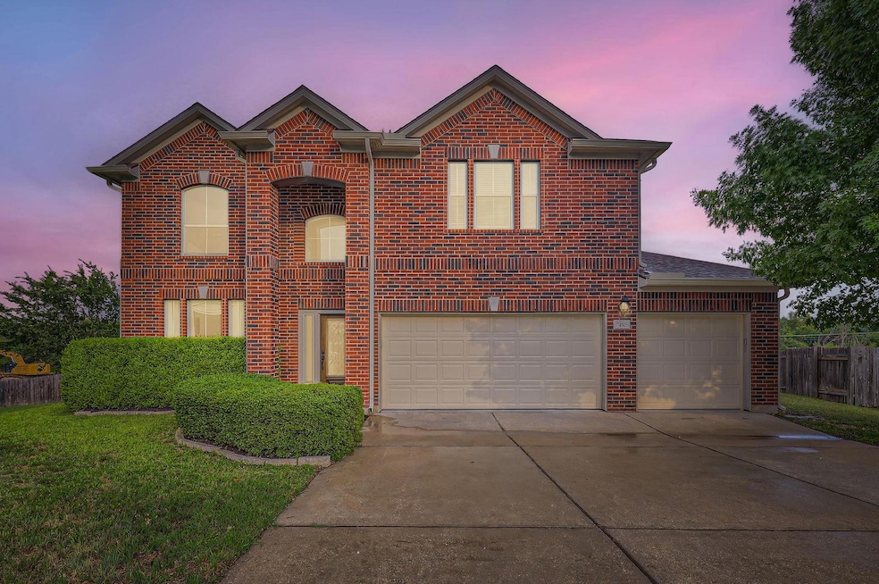 Traditional-style house with brick siding, drivew