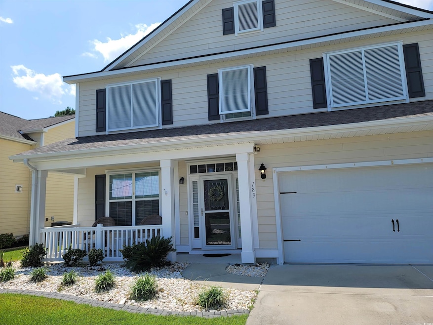 View of front facade with a porch and a garage