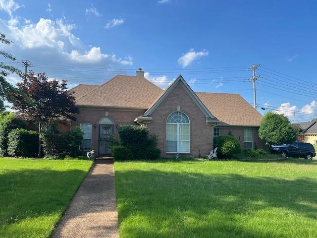 Single story home with a front lawn