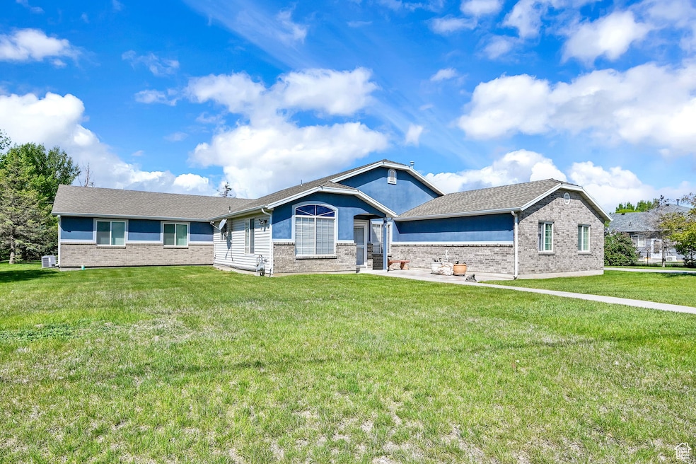 Single story home with brick siding and a front lawn