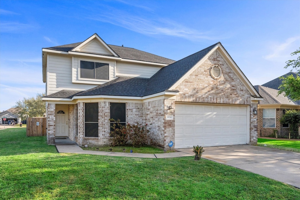 This two-story home features a charming brick and