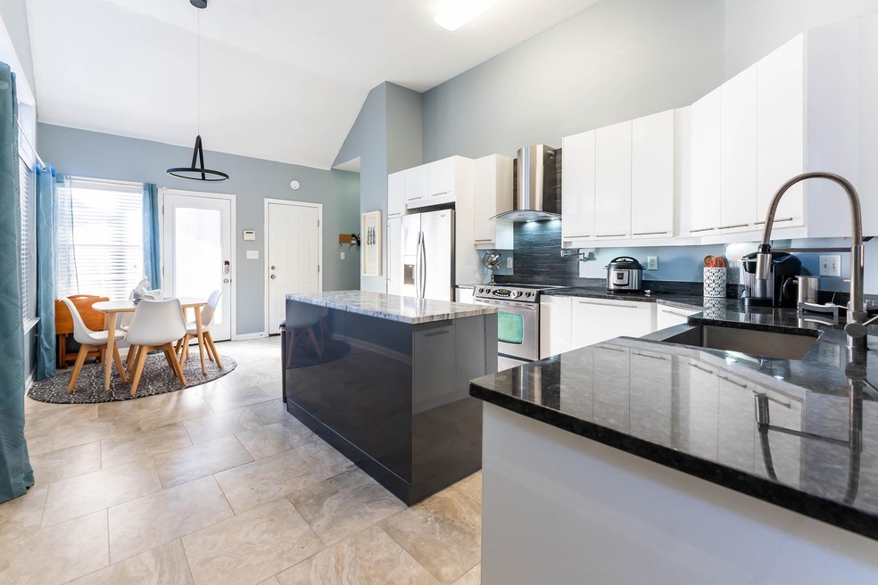 Open, eat-in kitchen with new tile floor, cabinets