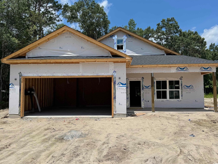 Unfinished property with a garage and roof with shingles