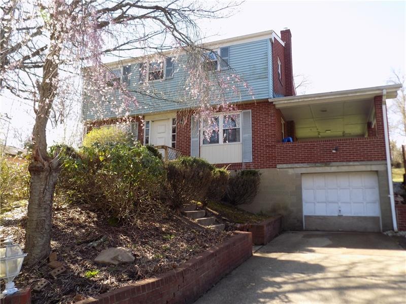 Two story red brick home with two lane driveway an