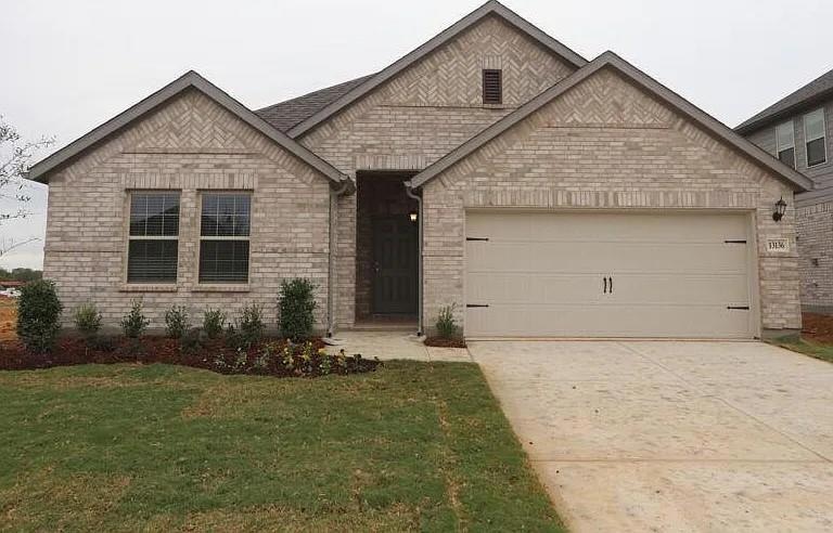 View of front of home with concrete driveway, bric