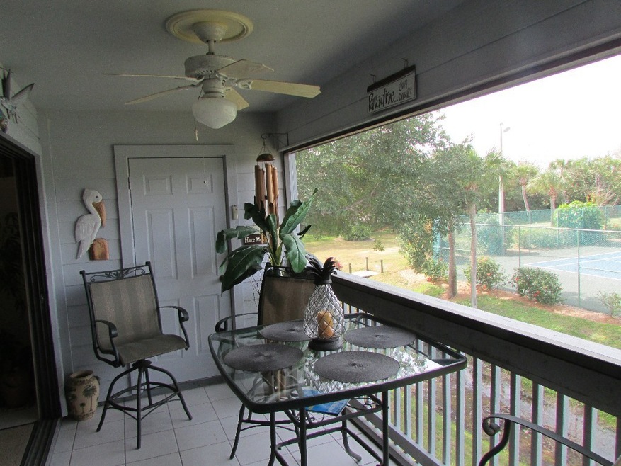 SCREEN PATIO WITH VIEW OF TENNIS COURTS