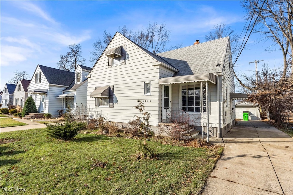 View of front of property with a garage and a front lawn