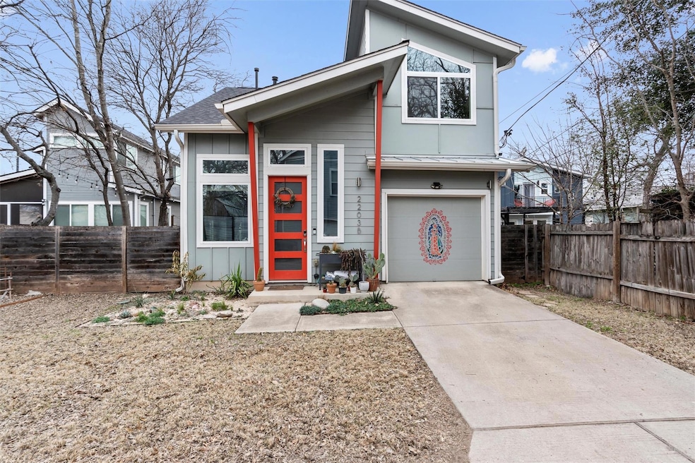 View of front of property featuring a garage, fen
