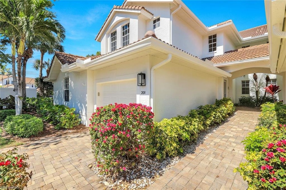 View of front of house with stucco siding, an atta
