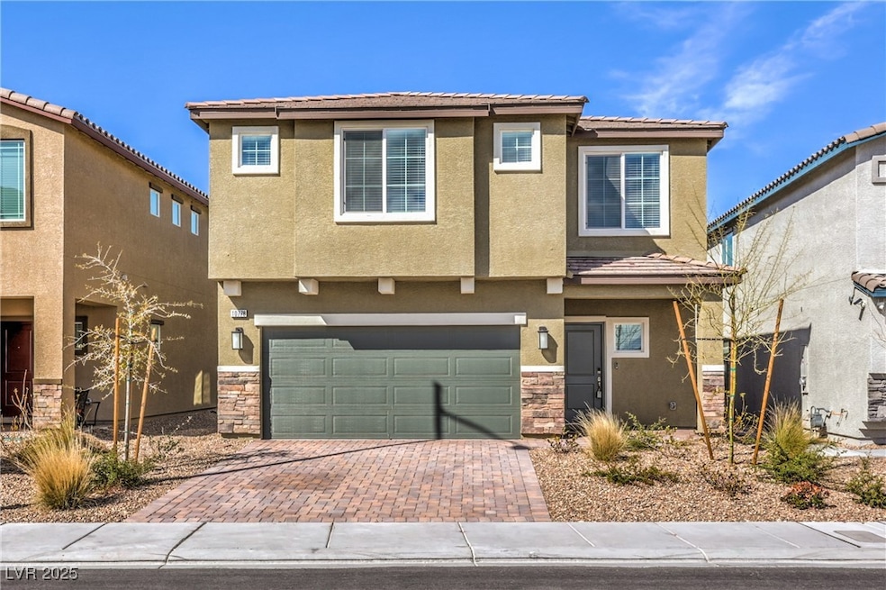 View of front of property with a garage, decorativ