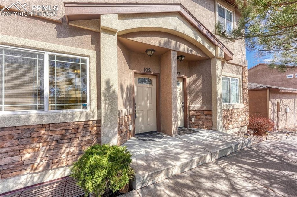 View of exterior entry with stucco siding and ston