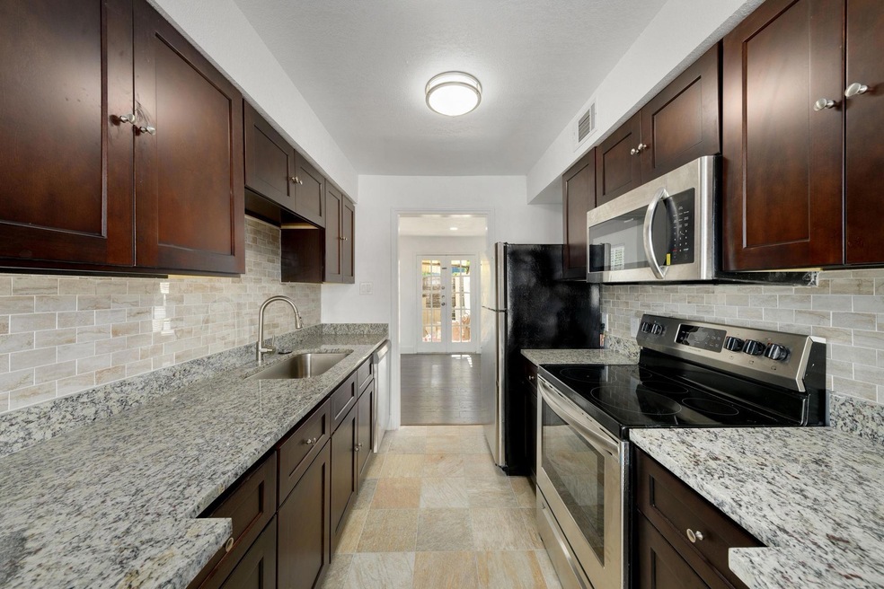 Kitchen with tasteful backsplash, appliances with 
