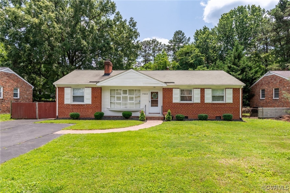 View of front of house with brick siding, a chimne