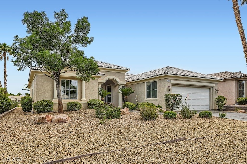 Welcome to this popular 6110 floor plan golf-course home displaying distinctive Mediterranean-style accented columns and an extended stamped concrete driveway and entrance walkway.