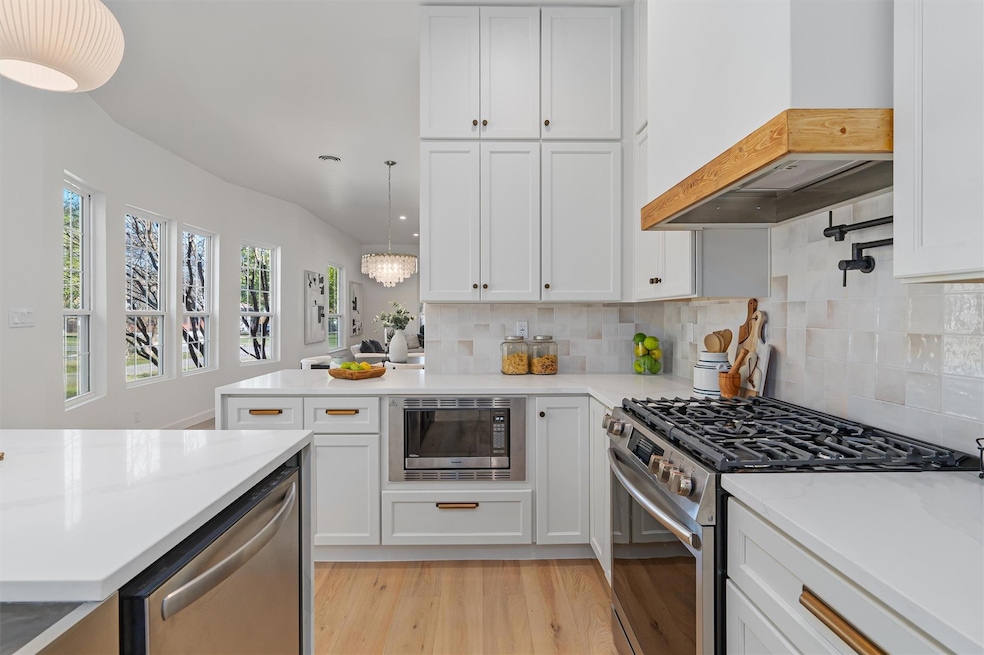 Kitchen with custom range hood, stainless steel a