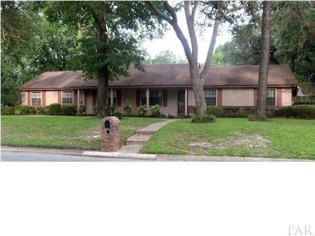 Custom built home with beautiful oak trees, luscious landscaping and a sprinkler system.