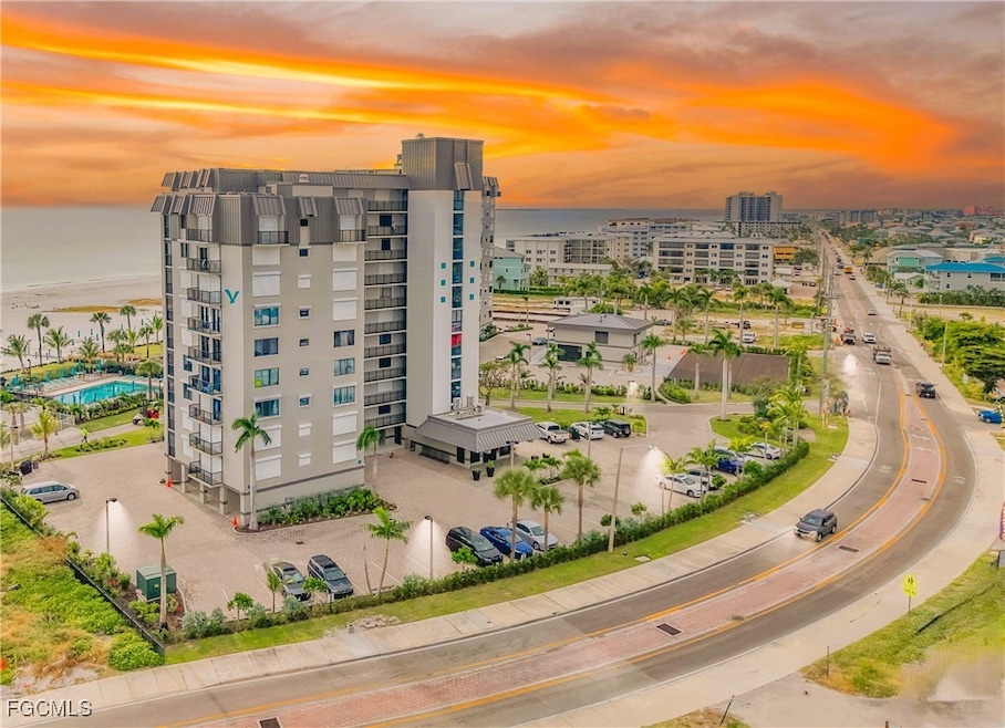 Aerial view at dusk of a water view, a view of city, and a view of apartment building / complex