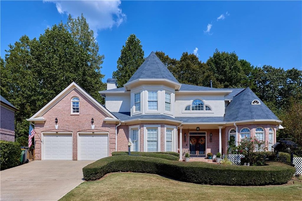 Victorian-style house with concrete driveway, bric
