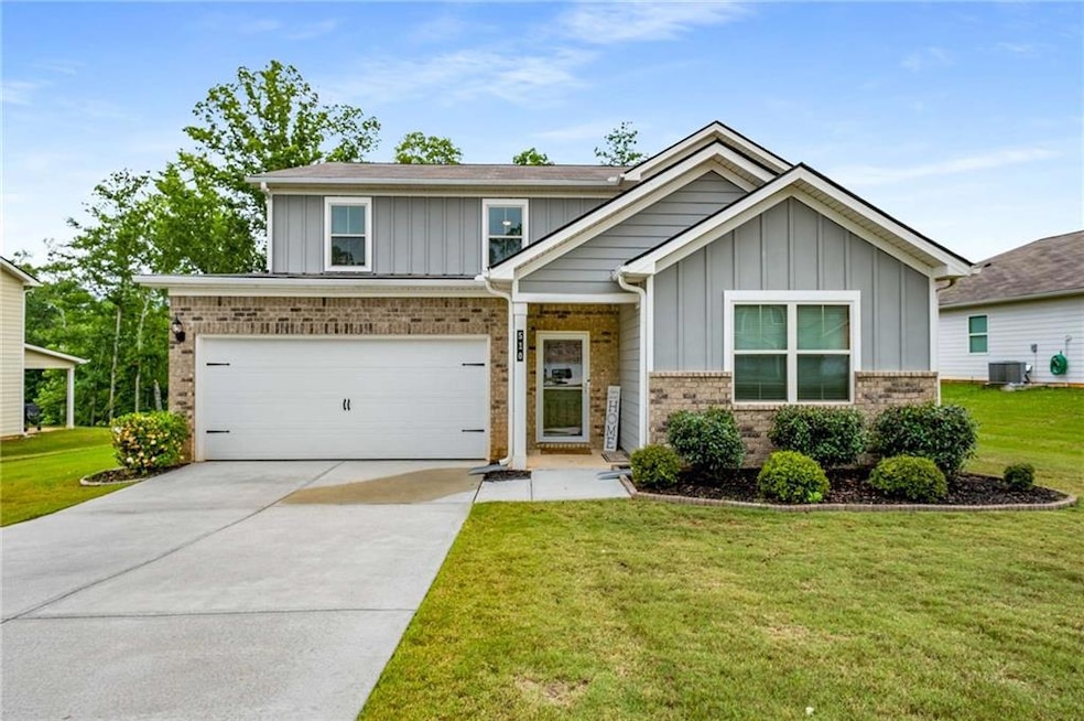 View of front of home featuring board and batten siding, central air condition unit, concrete driveway, and a front lawn