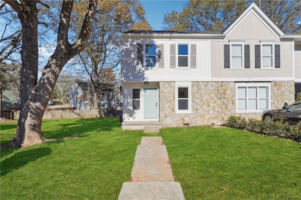 Colonial-style house featuring stone siding, a fro
