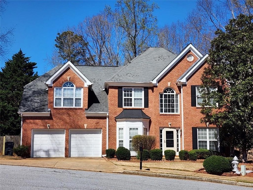 Colonial-style house with an attached garage, bric