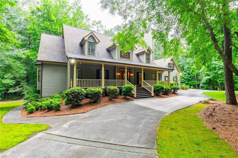 Cape cod house featuring a front lawn, driveway, a