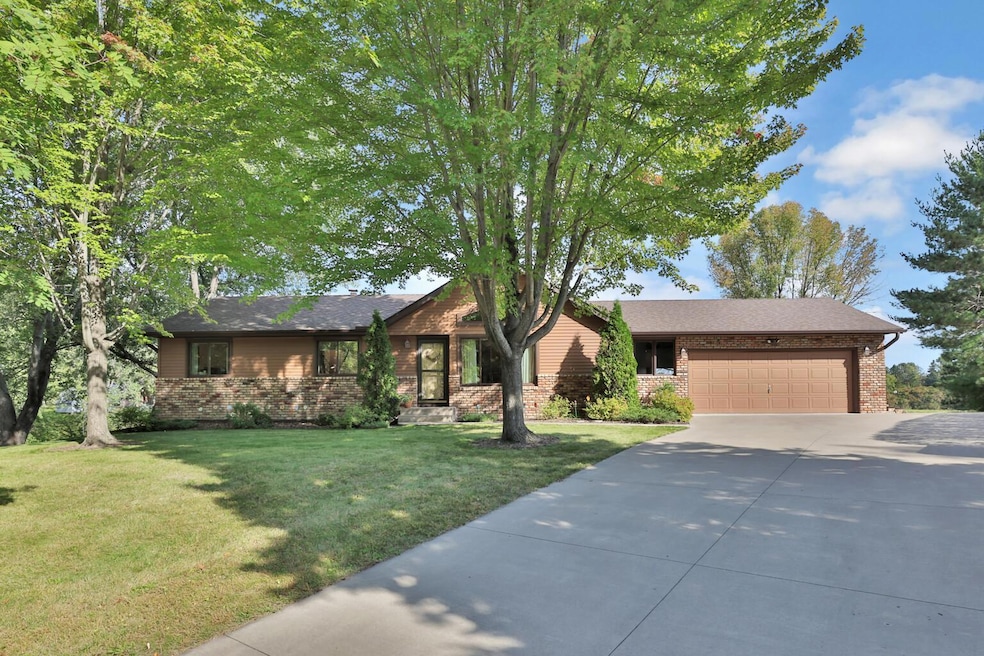 Solid built rambler with Andersen Windows, steel siding and oversized double garage, and concrete driveway.