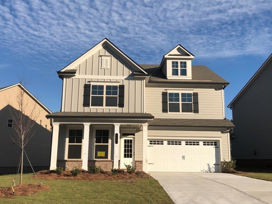 Craftsman-style house with a front lawn and a gara