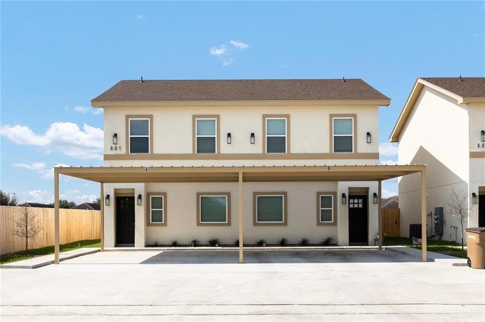 View of front of house featuring central AC unit, fence, and stucco siding