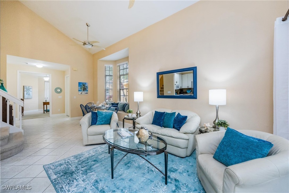 Tiled living room with high vaulted ceiling and ce