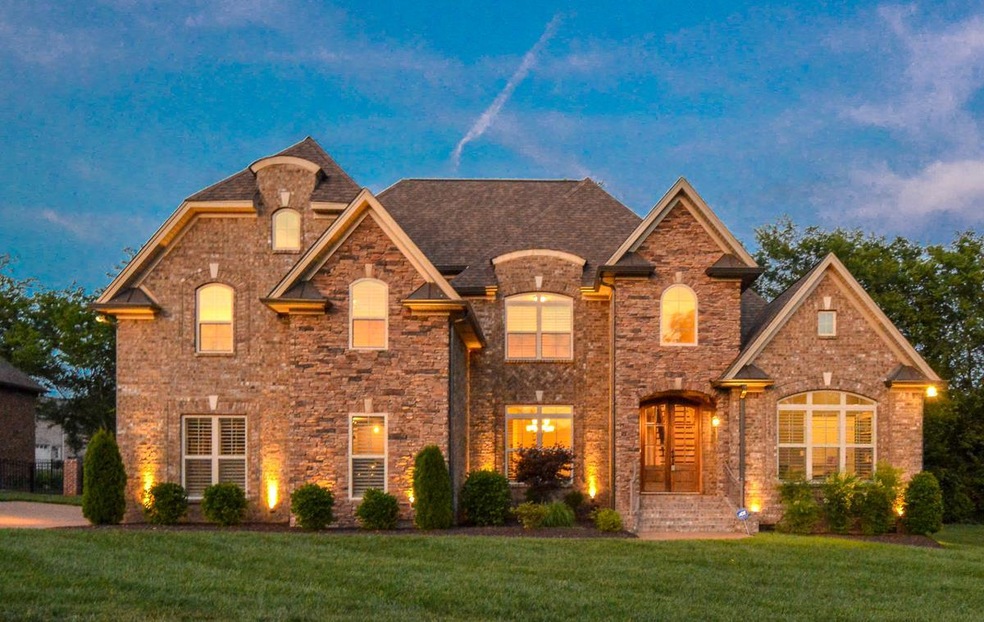 Impressive Front Elevation of Home with elegant landscape lighting