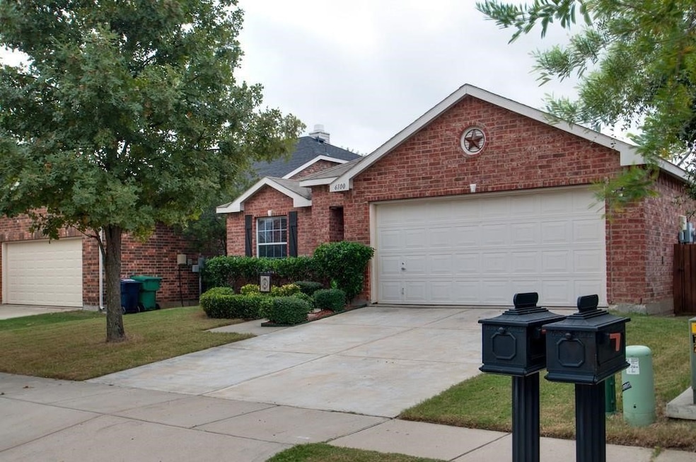 Ranch-style house featuring brick siding, concrete driveway, a front lawn, and an attached garage