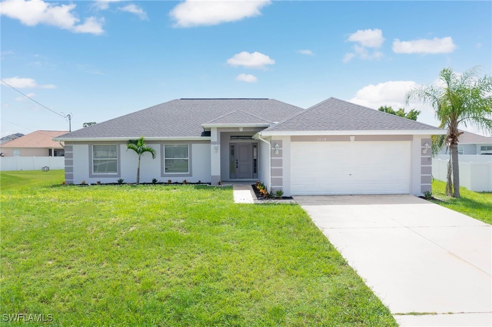 Single story home featuring a garage and a front l