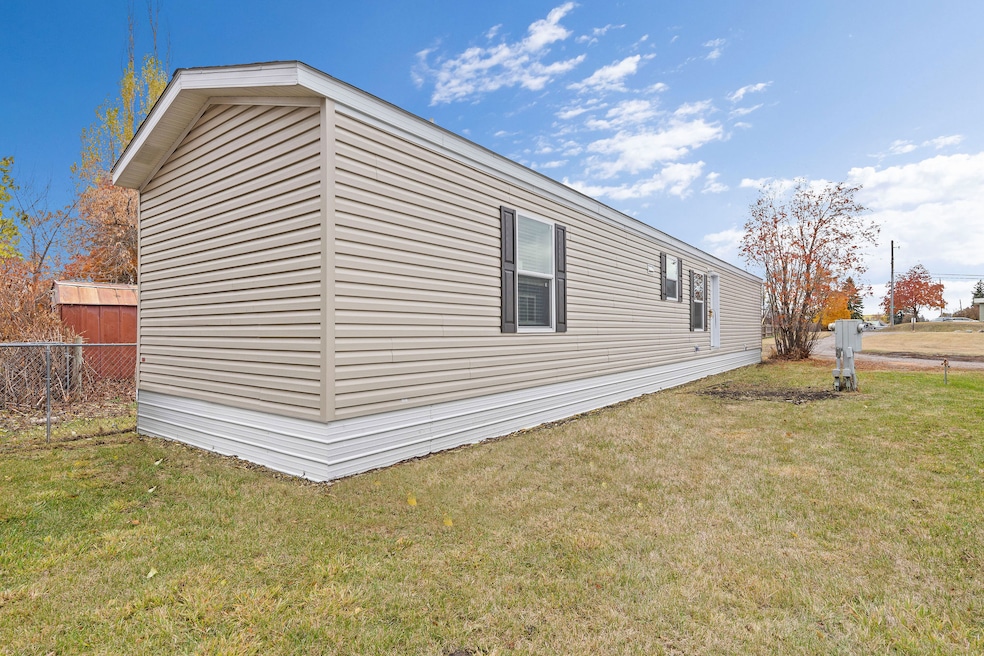 Side view of the 66' x 14' home, highlighting the modern windows and tidy exterior