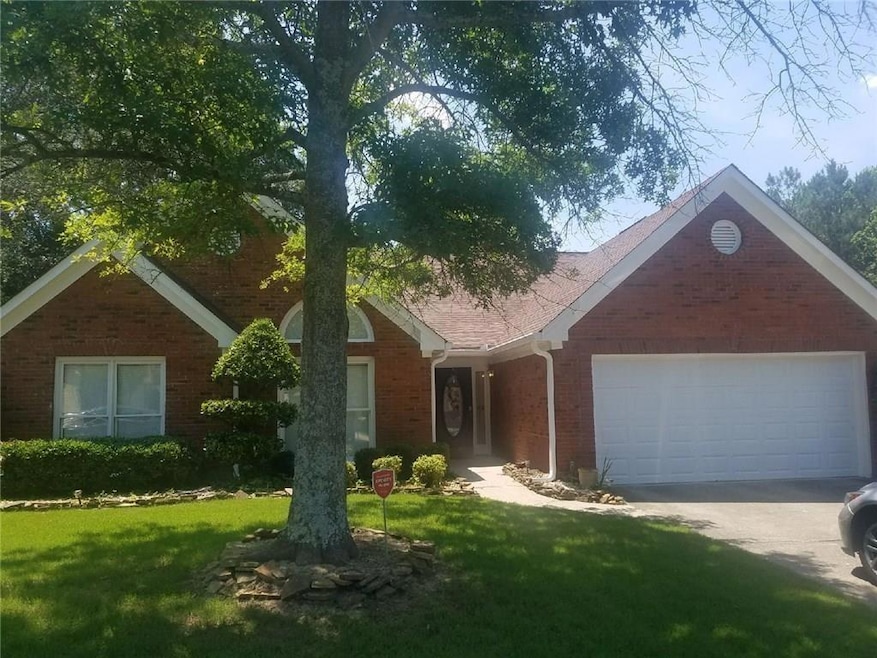 Single story home featuring brick siding, concrete