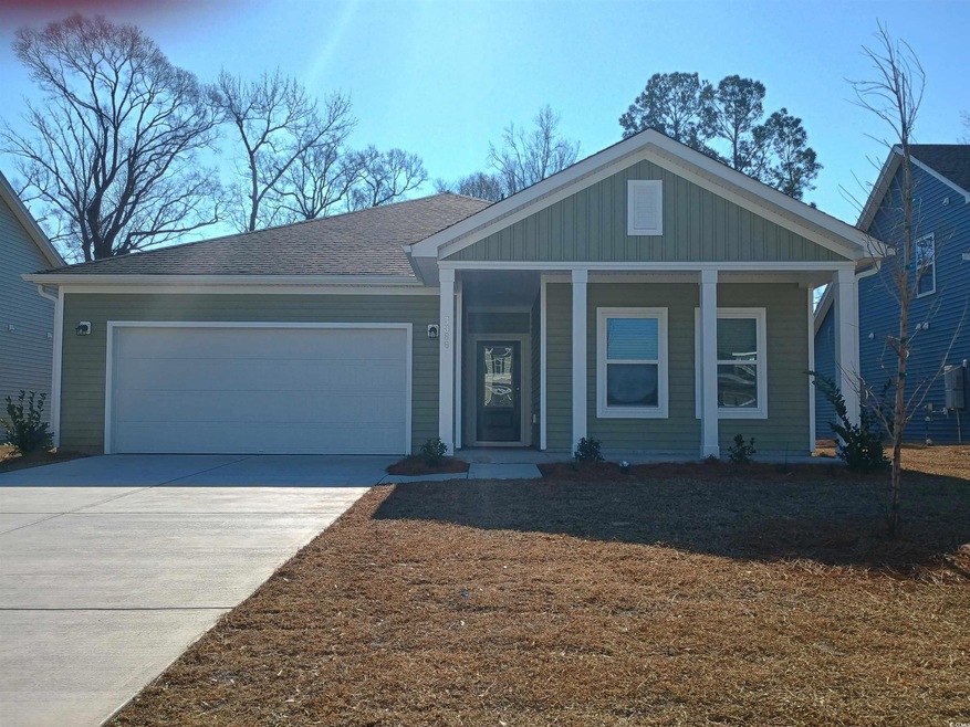 View of front of property featuring driveway, a ga