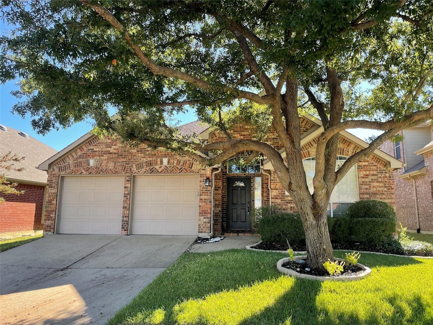 View of front of house featuring a garage and a front yard