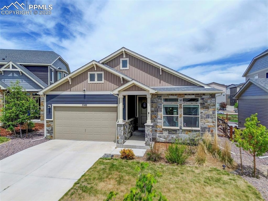 Craftsman inspired home with stone siding, a garag