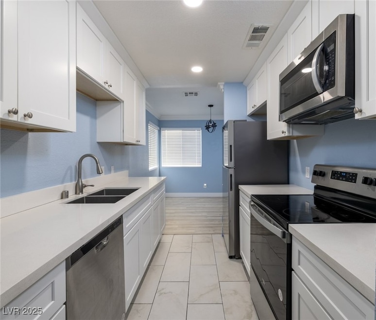 Kitchen includes stainless steel appliances white