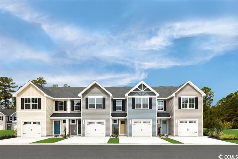 View of front of house featuring a garage and conc