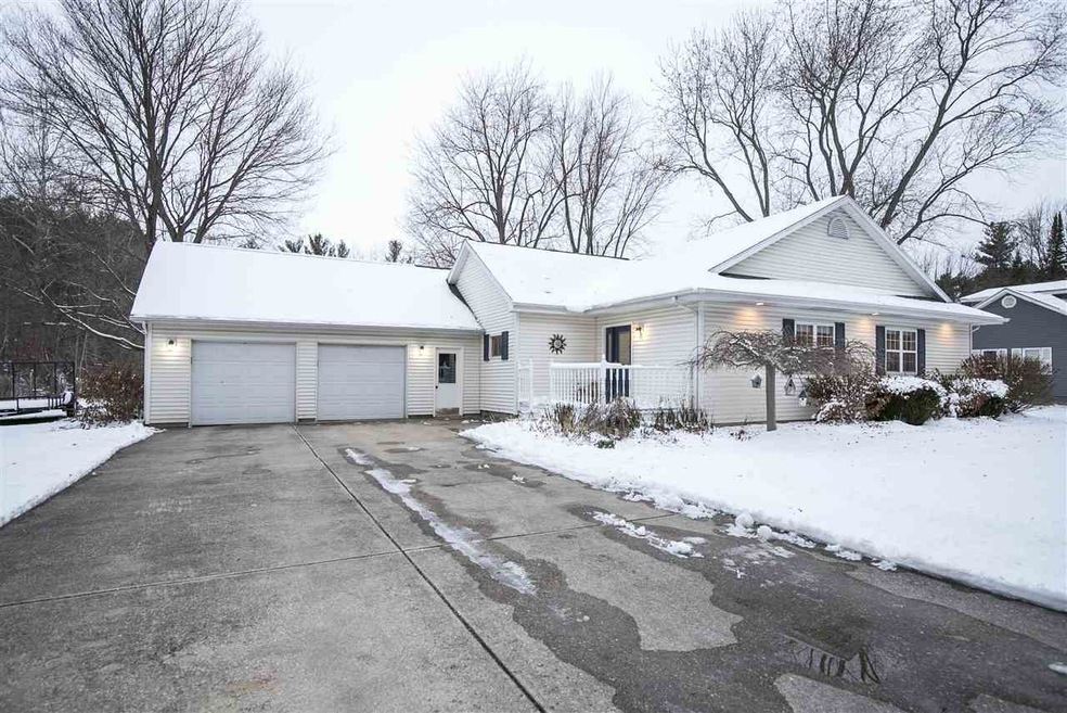 Concrete driveway leading to the 2-car attached ga