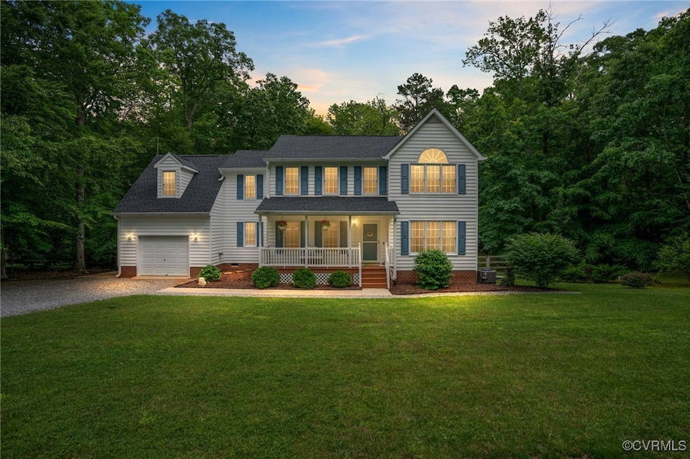 Colonial home featuring covered porch, driveway, a
