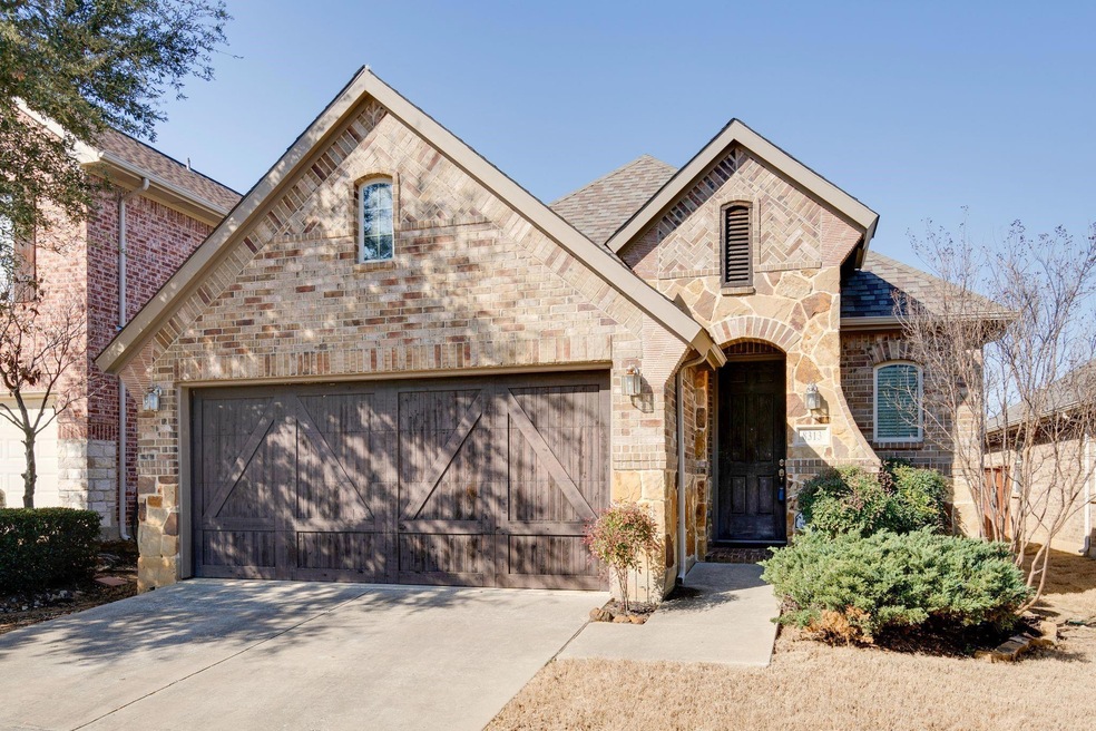 French country inspired facade featuring brick sid