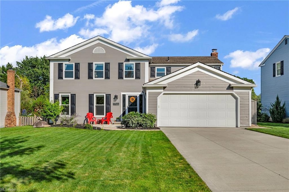 View of front facade with garage and a front lawn